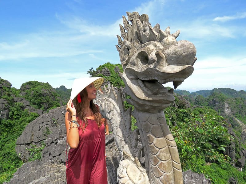 A tourist next to the dragon statue